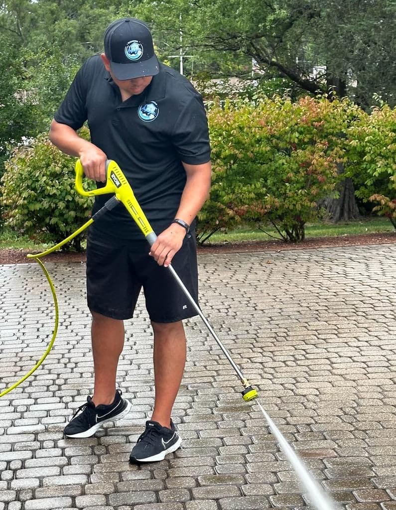 A driveway being pressure washed