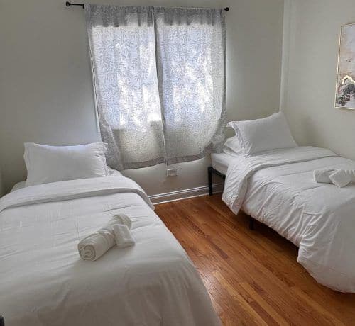 A guest bedroom staged with fresh linens for an Airbnb turnover